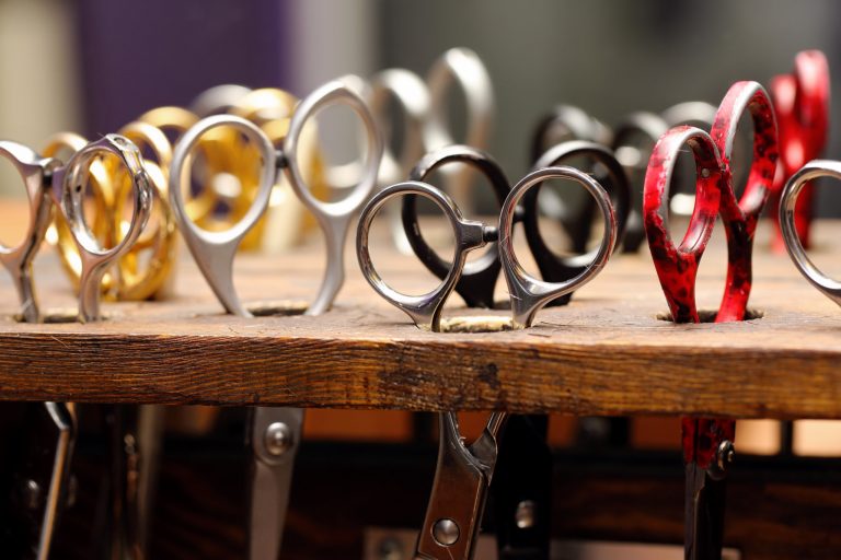 Hairdressing scissors in wooden stand